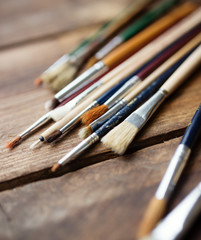 Fototapeta premium Paintbrushes on a wood background,