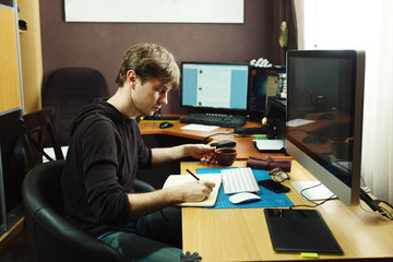 Freelance developer and designer working at home, man using desk