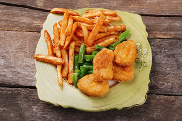Breaded fried chicken nuggets and potatoes with asparagus