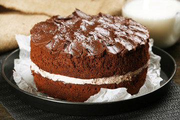 Delicious chocolate cake on table close-up
