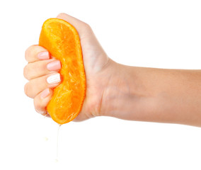 Female hand squeezing orange isolated on white