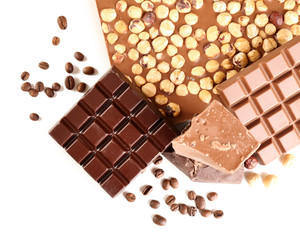 Chocolate bars with hazelnuts and coffee beans isolated on