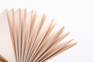 Open book pages in white background, close-up.