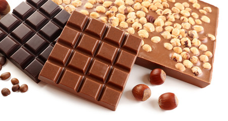 Chocolate bars with hazelnuts and coffee beans isolated on