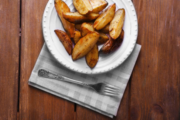 Baked potatoes on pate on wooden table