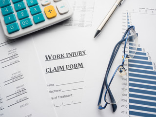 work injury claim form on desk.