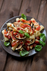 Typical italian pasta alla Norma, dark wooden background