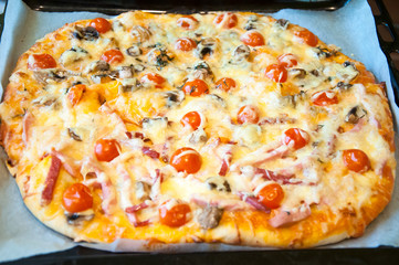 Italian pizza on the baking tray.