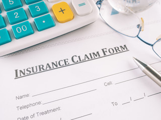 insurance claim form on the desk.