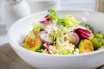 Healthy salad with couscous in a bowl