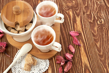 tea with sugar cubes on wooden