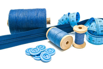 buttons, blue zipper and spools of thread
