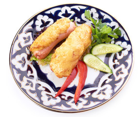 pile of chicken nuggets on white plate with sauce