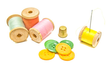 some spools of thread with buttons