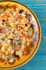 Uzbek pilaf, plov, pilaw with meat, carrot and berberries