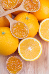 fresh orange with orange jam on wooden