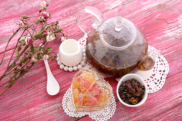 drink in glass teapot on wooden background