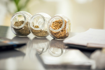 Herbal medicine - jars of herbs on the table. Homeopathy 