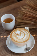Cup of latte coffee with tea
