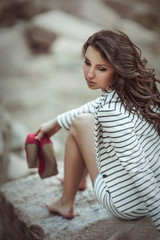 Fototapeta na wymiar girl sitting on a rock