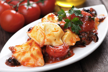 Tortellini pasta with tomato and olive sauce