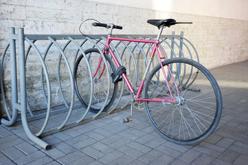 Fototapeta na wymiar the bike is tied to the rack on the street