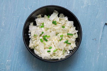 salad in a plate on a blue background