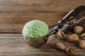pistachio ice cream ball in a spoon scoop