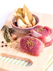Row tenderloin with herbs on cutting board. - Steak preparing an