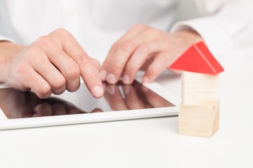 Home. Conceptual image of a man signing a mortgage or insurance