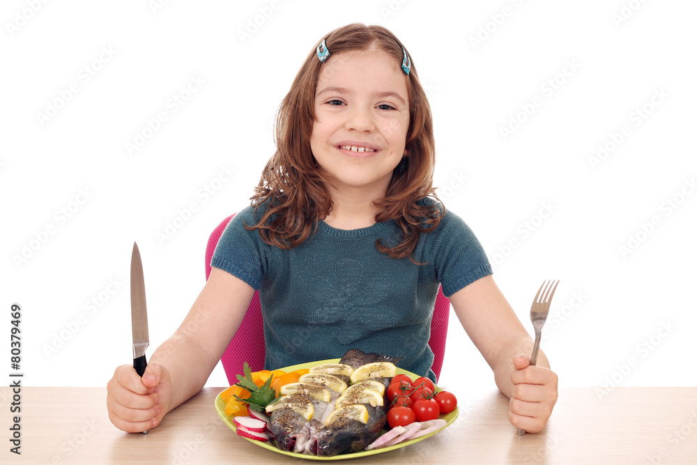 Wall mural hungry little girl with fish for lunch