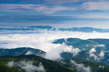 Clouds in the morning rise over the mountains in the Carpathians