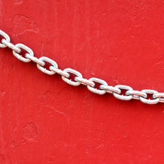 Closeup Chains on red wall background
