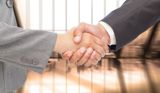 Composite image of handshake between two business people