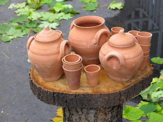 Clay pots on wooden support over autumn background