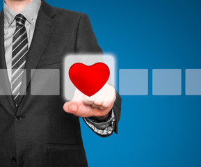 Businessman hand touch the heart on Visual screen. 