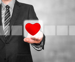 Businessman hand touch the heart on Visual screen. 