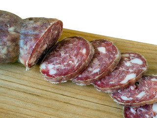 Artisan homemade salami, sausage on board. Closeup. Sliced.