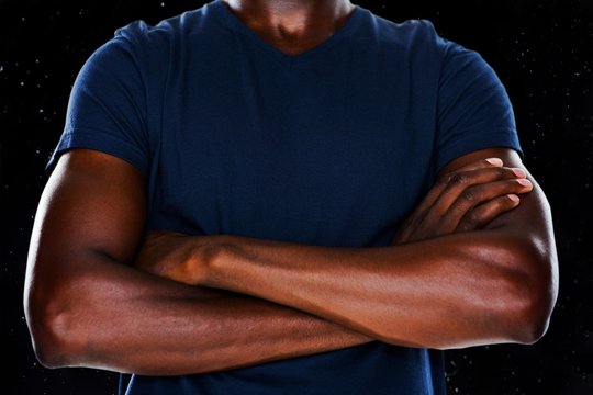 Composite image of close up mid section of man with arms crossed