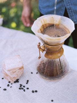 An apple orchard in Utah. man standing at a table, making coffee.