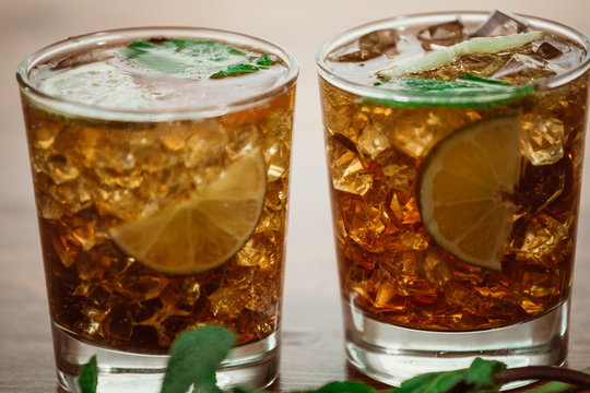 drink concept - cocktail with  cola ice cubes and lime