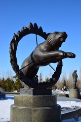 Statue featuring a circus tiger jumping through a burning ring