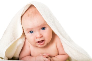 Smiling. Smiling baby looking at camera under a white blanket