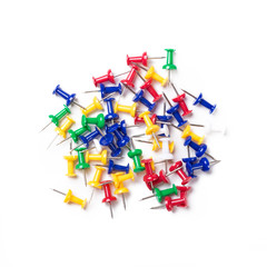 colorful push pins on white background.