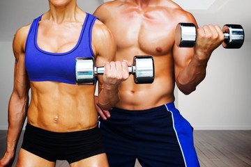 Fototapeta na wymiar Composite image of bodybuilding couple