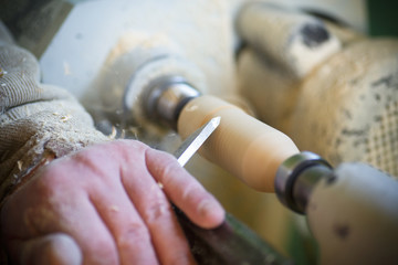hand with a chisel in the course of the woodwork