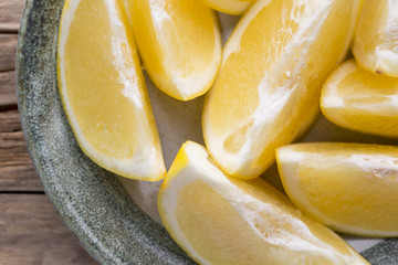 Yellow grapefruit slice on a plate.