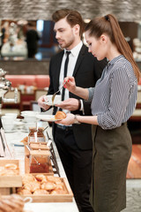 Business managers take croissants and jam at the buffet