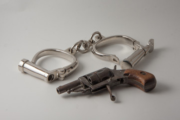 old handcuffs and revolver