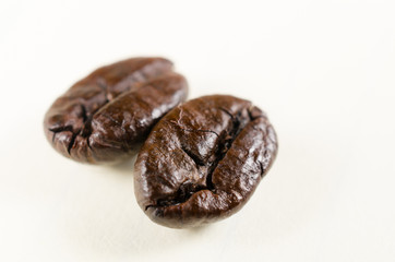 close up of roasted coffee beans isolated on white background